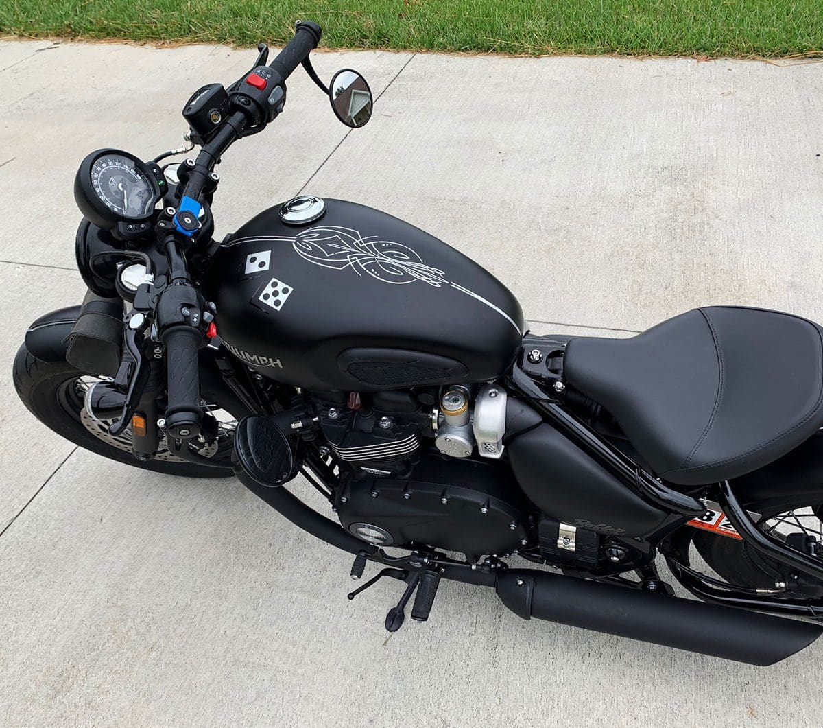 A black motorcycle parked on the side of a road.