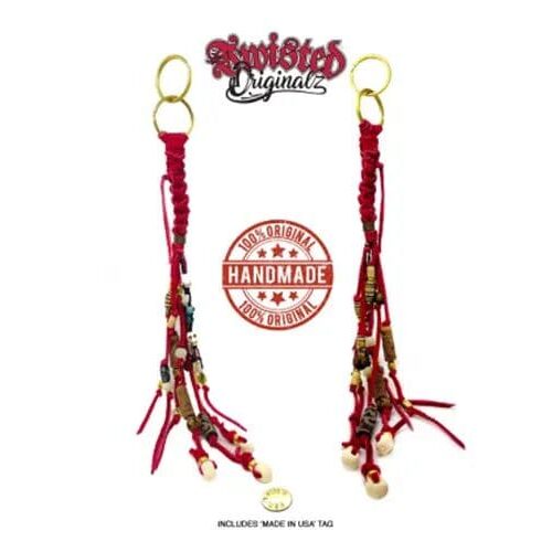 A pair of red and gold hair clips with beads.