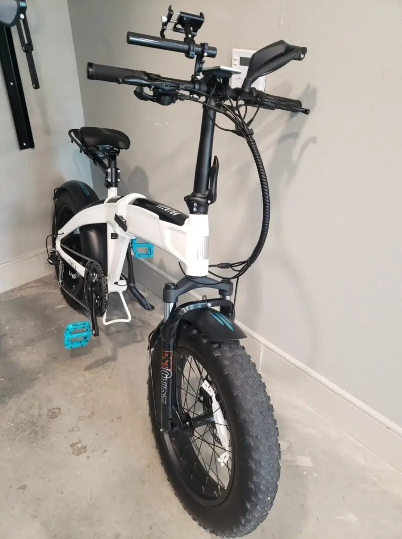 A white bike is parked in the garage