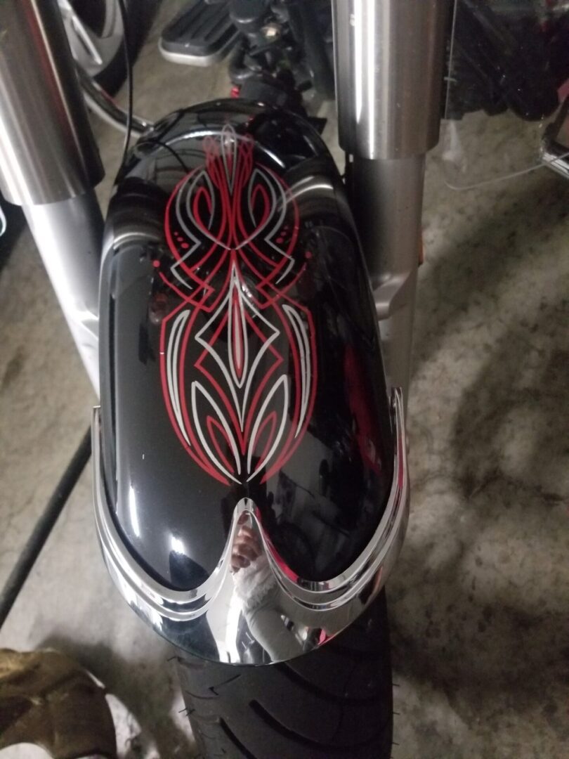 A motorcycle with red and black designs on it.