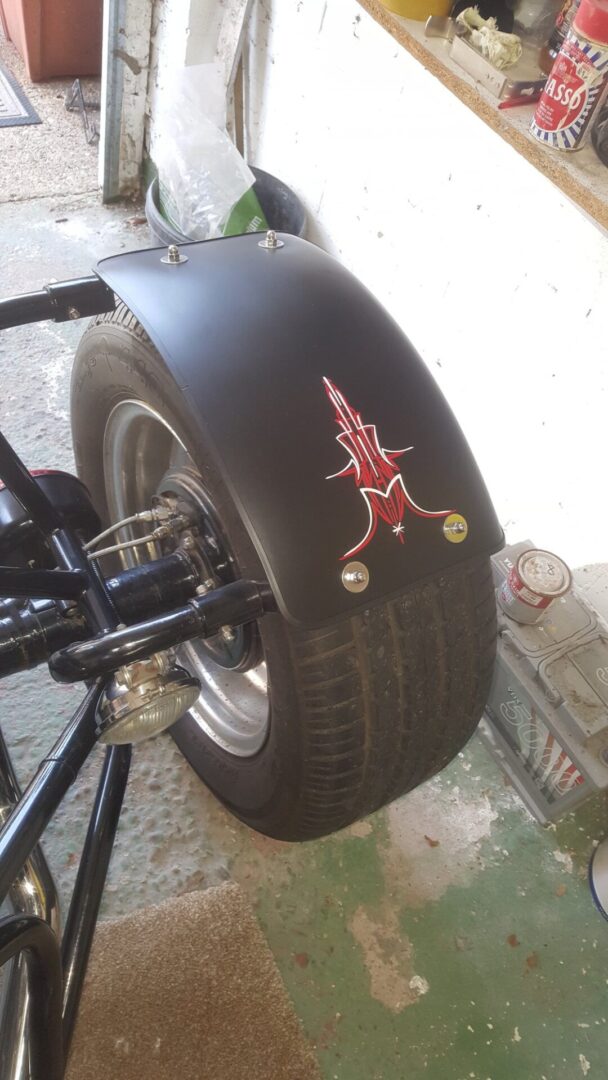 A tire with a sticker on it is shown.