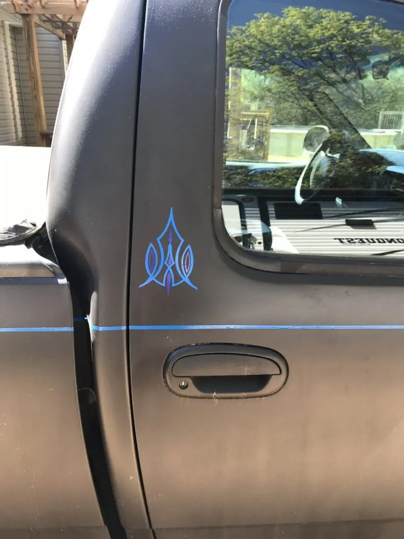 A truck with blue flames on the side of it.
