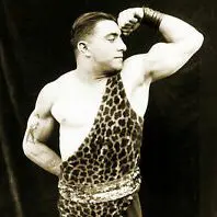 A man in leopard print shirt and shorts posing for the camera.